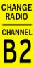 Yellow sign with the text Change Radio Channel B2 in black